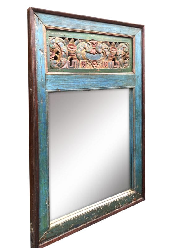 A mirror with a blue frame and a floral design.