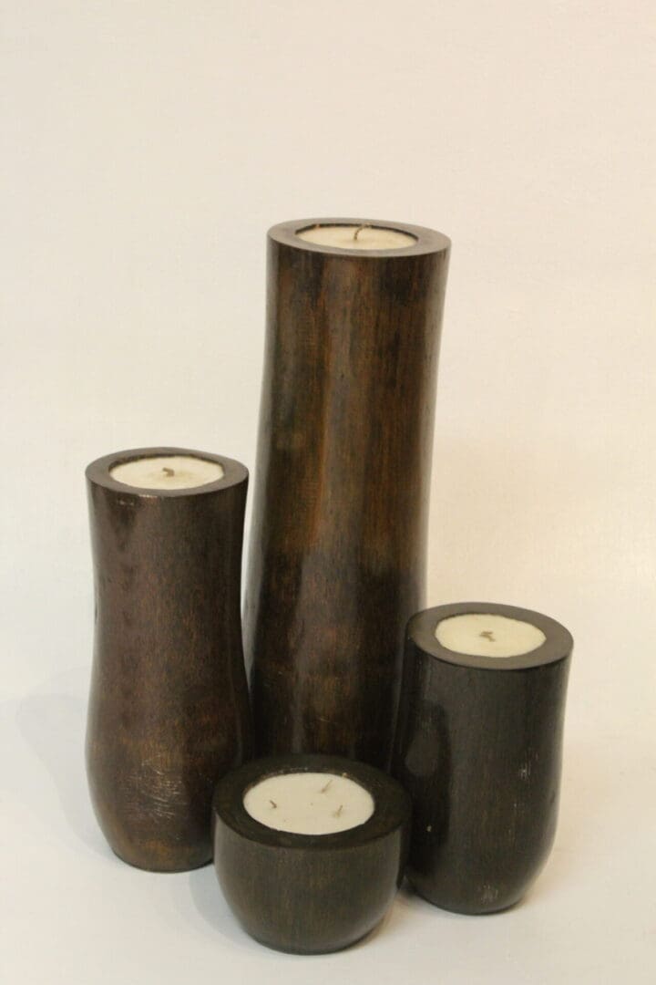 A group of four candles that are sitting on top of each other.