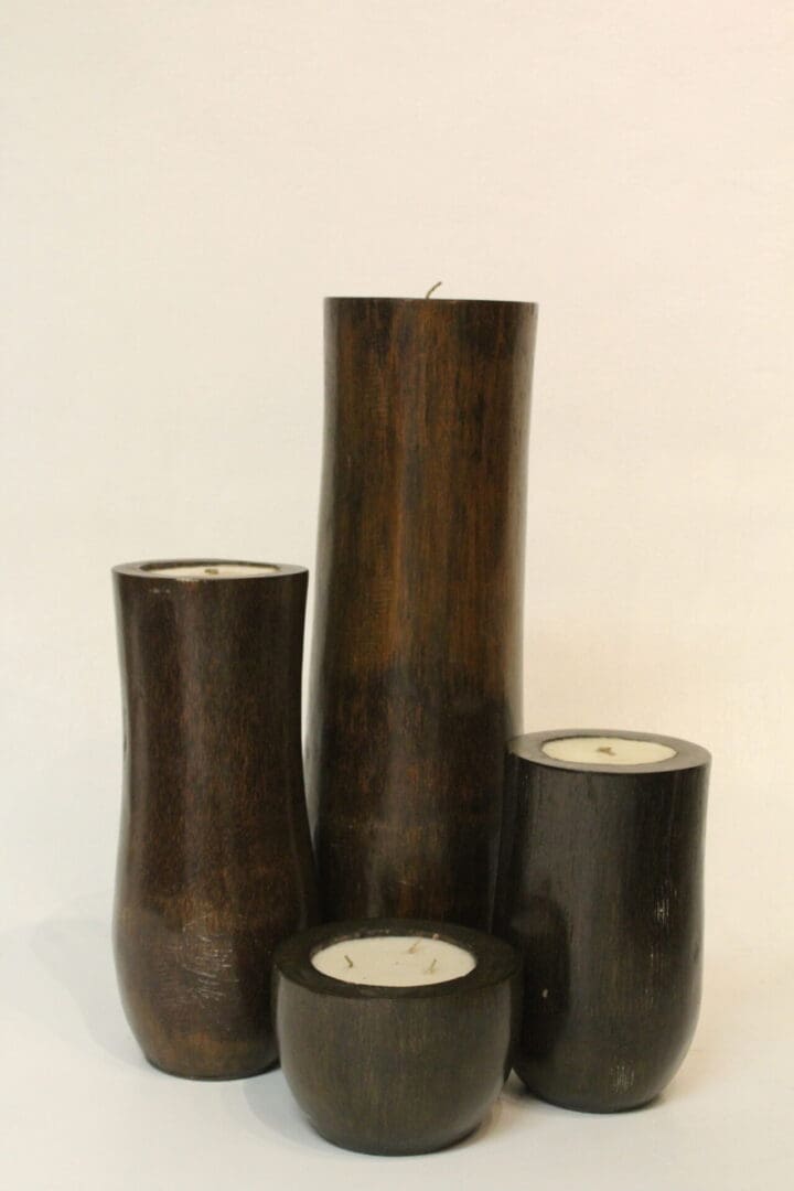 A group of four candles that are sitting on top of each other.