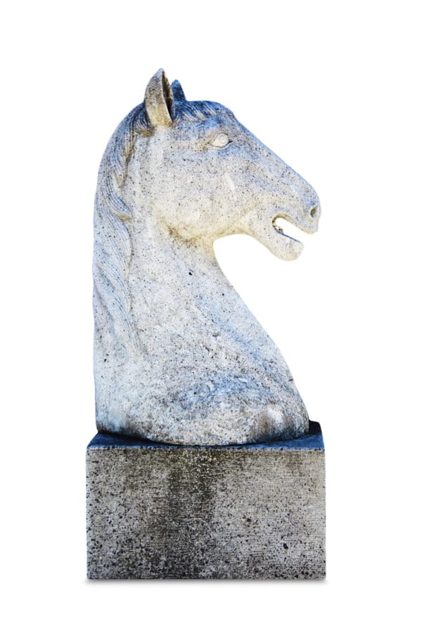 A horse statue is shown on top of a stone base.