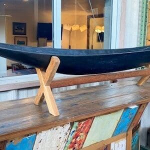 A boat on display in front of a window.