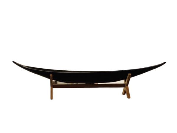 A black hammock on top of wooden stand.