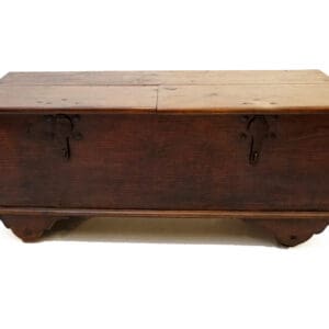 A wooden trunk with metal handles and two drawers.