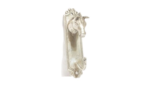 A white door handle with a horse head on it.