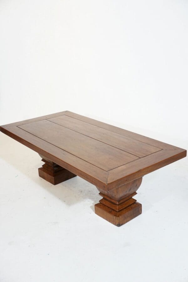 A wooden table with two pillars on top of it.
