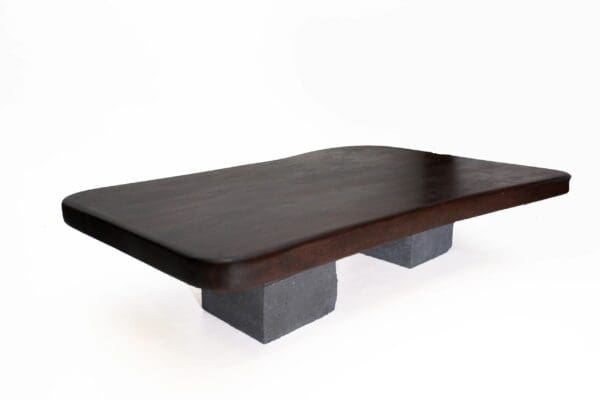 A wooden table with concrete bases on top of it.