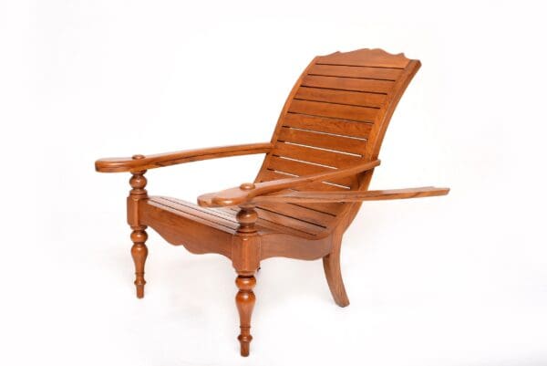 A wooden chair with an arm rest on it.