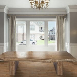 A large wooden table in front of a window.