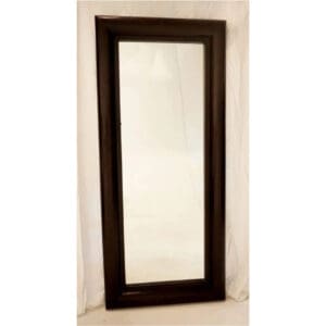 A mirror with a wooden frame on the wall.