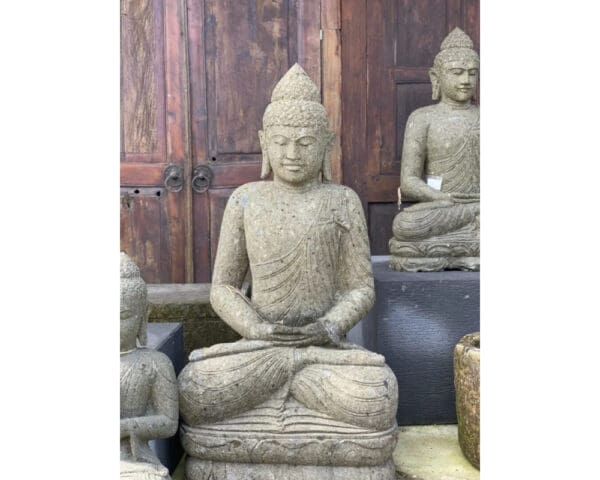 A statue of buddha sitting in the middle of a room.