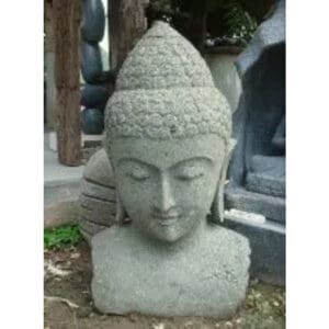 A statue of buddha is shown in front of trees.