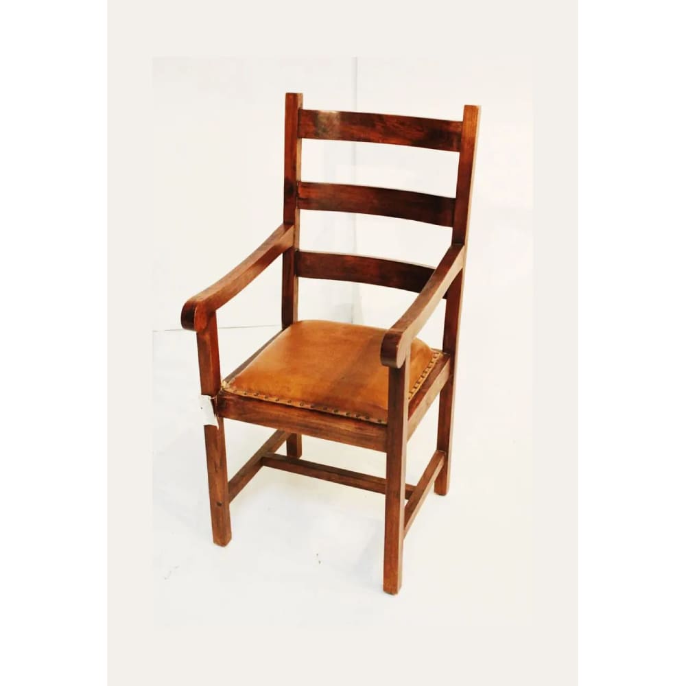 A wooden chair with brown leather seat.