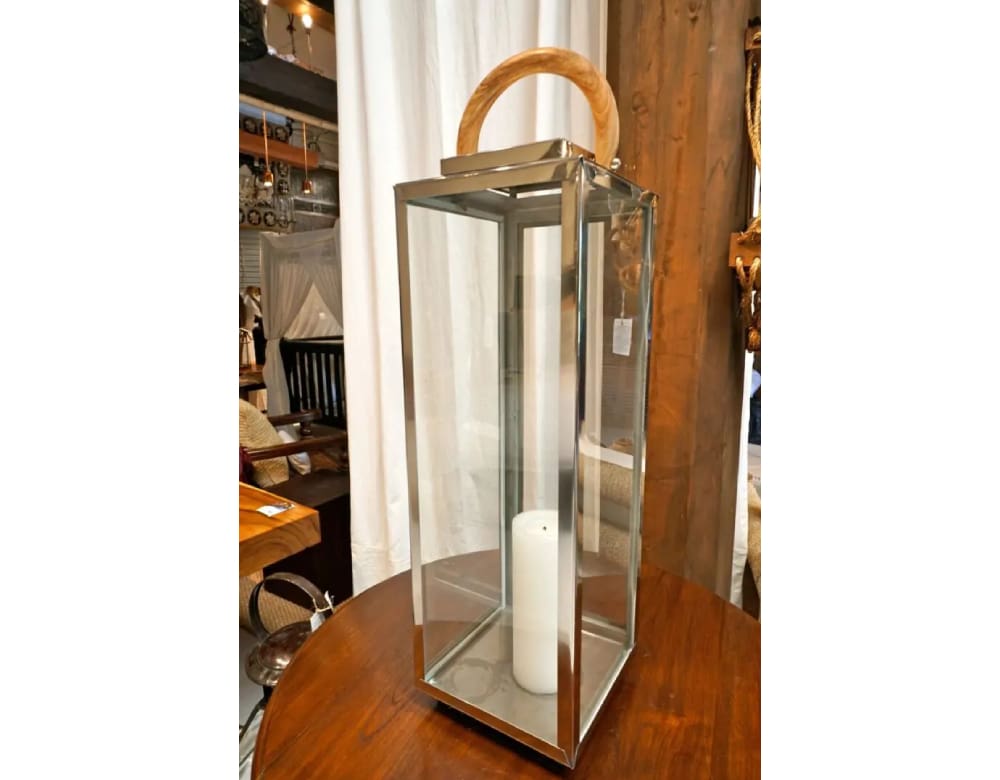 A large glass and metal lantern with a candle.