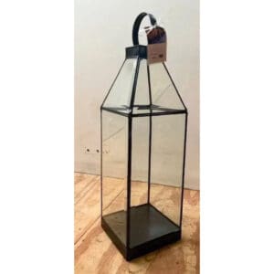 A tall glass lantern with a black metal base.
