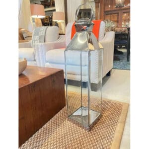 A glass and metal stand with orange accents.