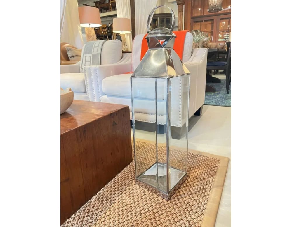 A glass and metal stand with orange accents.