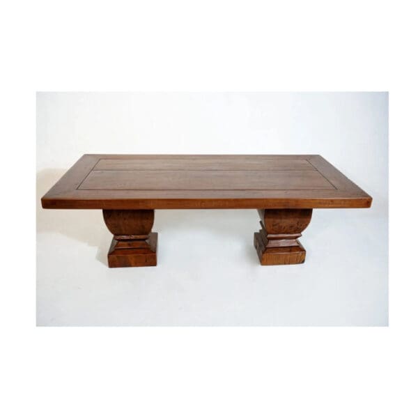 A wooden table with two pillars on top of it.