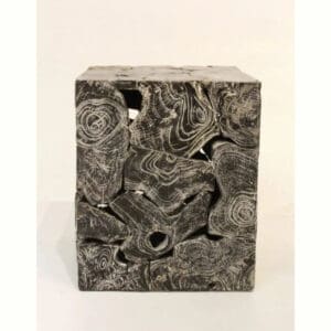 A stone cube with some interesting designs on it