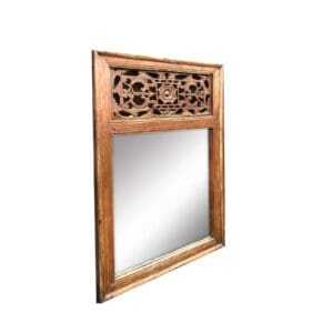 A mirror with a wooden frame and carved design.