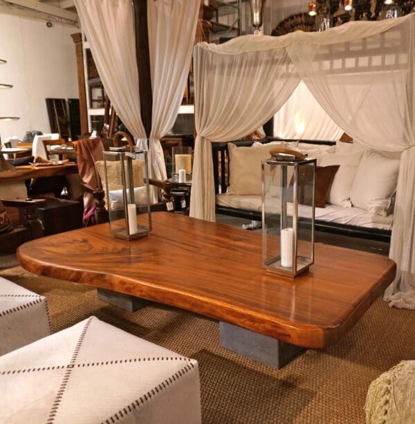 A wooden table with metal legs and a vase on top.