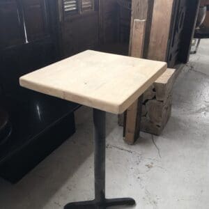 Wooden table with black metal base.