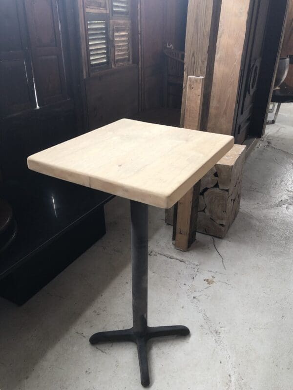 Wooden table with black metal base.